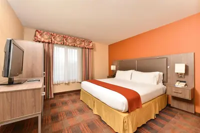 a hotel room with a large bed and a television at HOLIDAY INN EXPRESS & SUITES ELK GROVE CENTRAL - HWY 99 by IHG in Elk Grove