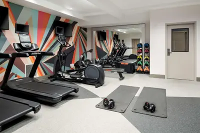 a gym with several treadmills and exercise bikes at Hilton Garden Inn Folsom in Folsom