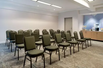 a room with a row of chairs in a classroom at Hilton Garden Inn Folsom in Folsom