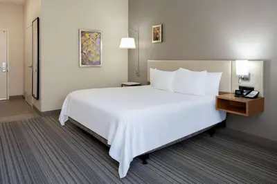 a large white bed in a hotel room at Hilton Garden Inn Roseville in Roseville