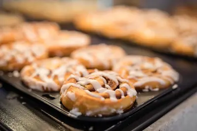 a tray of glazed donuts sitting on a table at Holiday Inn Express Hotel & Suites Modesto-Salida by IHG in Modesto