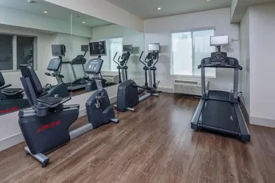 a gym with several treadmills and elliptical machines at Holiday Inn Express Hotel & Suites Modesto-Salida by IHG in Modesto