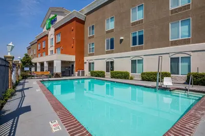 a large swimming pool in front of a building at Holiday Inn Express Hotel & Suites Modesto-Salida by IHG in Modesto