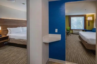 a hotel room with two beds and a sink at Holiday Inn Express Hotel & Suites Modesto-Salida by IHG in Modesto