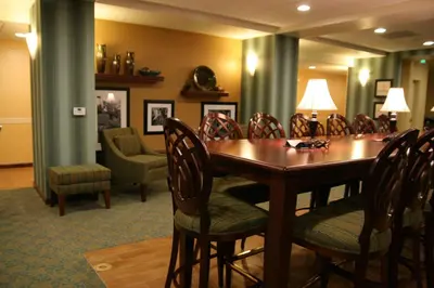 a conference room with a wooden table and chairs at Hampton by Hilton in Brentwood