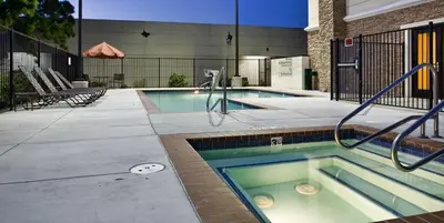 a swimming pool with a hot tub in a building at Hampton by Hilton in Brentwood