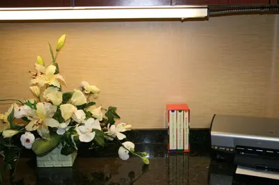 a vase of flowers on a counter next to a printer at Hampton by Hilton in Brentwood