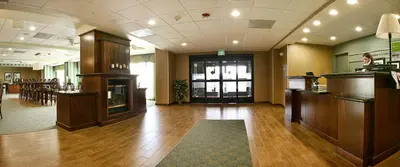 a large room with a lobby with wooden floors at Hampton by Hilton in Brentwood