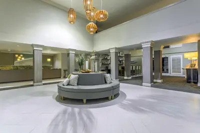 a large lobby with a couch in the middle of it at Holiday Inn Auburn by IHG in Auburn