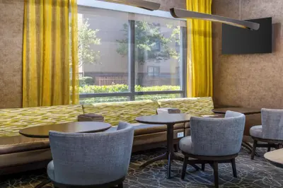 a restaurant with tables and chairs and a large window at SpringHill Suites by Marriott Sacramento Roseville in Roseville