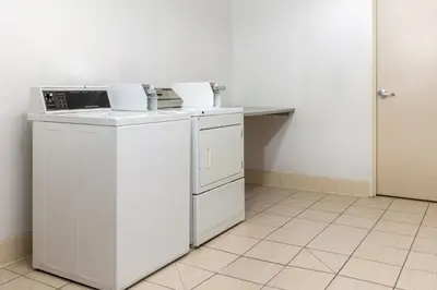 a white laundry room with a washer and dryer at SpringHill Suites by Marriott Sacramento Roseville in Roseville