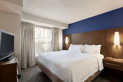 a hotel room with a large bed and a television at Residence Inn by Marriott Roseville in Roseville