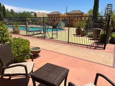 a wrought iron fence with a pool in the background at Holiday Inn Express Hotel & Suites El Dorado Hills by IHG in El Dorado Hills