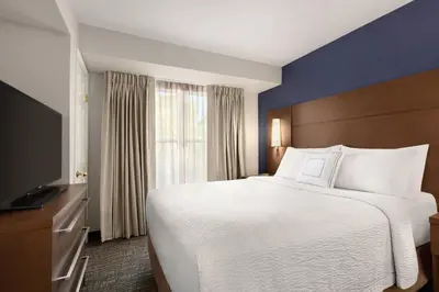 a hotel room with a bed and a television at Residence Inn Sacramento Folsom in Folsom