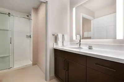 a bathroom with a sink and a shower with a mirror at Residence Inn Sacramento Folsom in Folsom