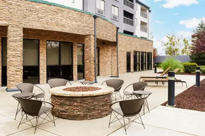 a patio with chairs and a fire pit in front of a building at Courtyard by Marriott Sacramento Folsom in Folsom