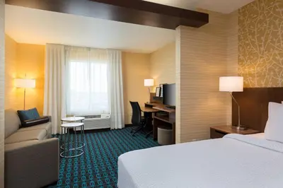 a hotel room with a bed and a desk at Fairfield Inn & Suites by Marriott Sacramento Folsom in Folsom