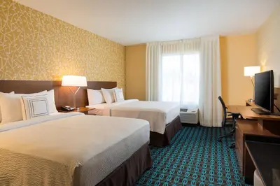 a hotel room with two beds and a flat screen tv at Fairfield Inn & Suites by Marriott Sacramento Folsom in Folsom