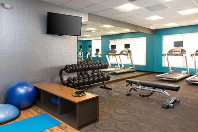 a gym with several treadmills and weights at Fairfield Inn & Suites by Marriott Sacramento Folsom in Folsom