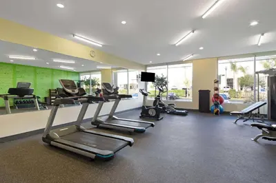 a gym with several exercise bikes and a tv at La Quinta by Wyndham Morgan Hill-San Jose South in Morgan Hill