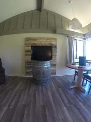 a living room with a table and a television on a barrel at Ridgemark Golf Club and Resort in Hollister