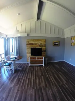 a living room with a fireplace and a dining table at Ridgemark Golf Club and Resort in Hollister