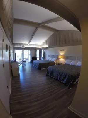 a large room with two beds and a hallway at Ridgemark Golf Club and Resort in Hollister