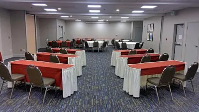 a conference room with tables and chairs and tablesearcher at Holiday Inn Express & Suites Tracy by IHG in Tracy