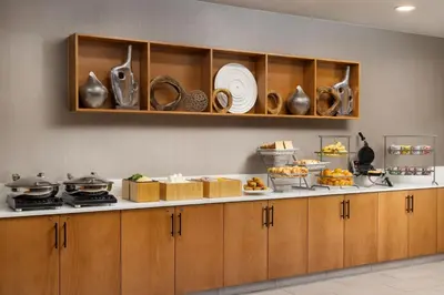 a kitchen with a counter with food on it at SpringHill Suites Fresno in Fresno