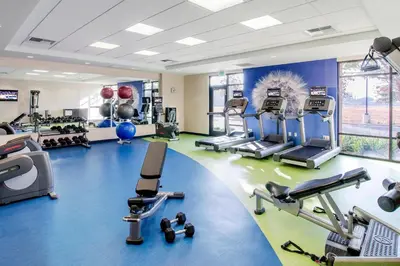 a gym with several treadmills and cardio machines at SpringHill Suites Fresno in Fresno