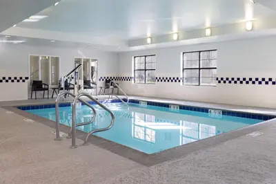 a large swimming pool with blue water in a building at TownePlace Suites by Marriott Sacramento Roseville in Roseville