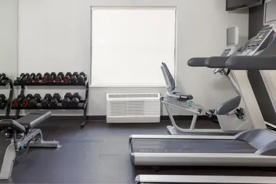 a gym with a treadmill and exercising equipment and a window at TownePlace Suites by Marriott Sacramento Roseville in Roseville