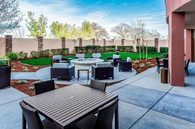a patio with tables and chairs in a yard at Courtyard by Marriott Roseville Galleria Mall/Creekside Ridge Drive in Roseville