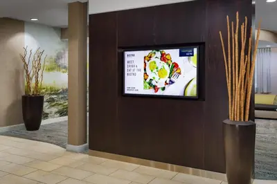 a flat screen tv on a wall in a lobby at Courtyard by Marriott Roseville Galleria Mall/Creekside Ridge Drive in Roseville