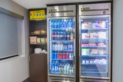 a refrigerator filled with lots of soda and drinks at Holiday Inn Express Hotel & Suites Bishop by IHG in Bishop