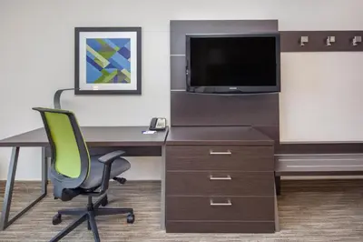 an office with a desk with a television and a chair at Holiday Inn Express Hotel & Suites Bishop by IHG in Bishop