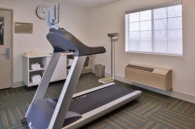 a gym with a treadmill and a window at Holiday Inn Express Westley by IHG in Westley