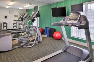 a fitness room with tread machines and a flat screen tv at Holiday Inn Express Westley by IHG in Westley