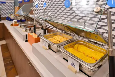 a buffet line with trays of food on display at Holiday Inn Express Westley by IHG in Westley