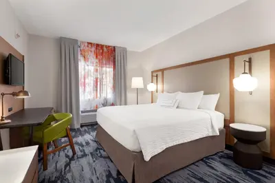 a hotel room with a large bed and a desk at Fairfield Inn by Marriott Visalia Sequoia in Visalia