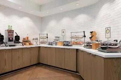 a restaurant with a counter with food on it at Fairfield Inn by Marriott Visalia Sequoia in Visalia