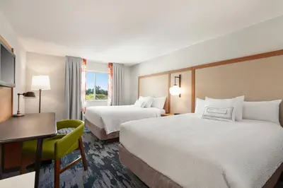a hotel room with two beds and a desk at Fairfield Inn by Marriott Visalia Sequoia in Visalia