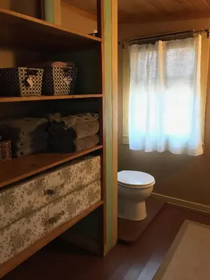 a bathroom with a toilet and a window at Merrynook in Pinehurst