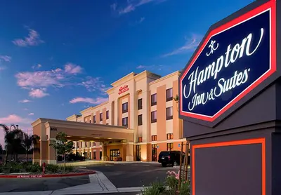 a sign for a store in front of a building at Hampton Inn & Suites Clovis Airport North in Clovis
