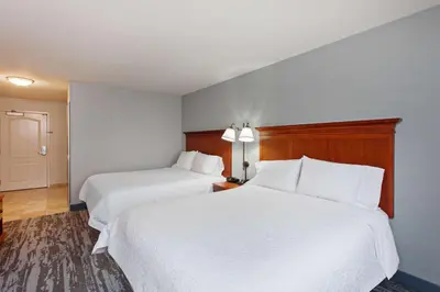 two beds in a hotel room with white sheets at Hampton Inn & Suites Clovis Airport North in Clovis