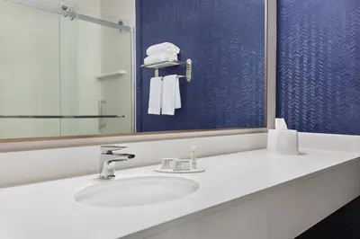 a bathroom with a sink and a mirror at Fairfield Inn by Marriott Tracy in Tracy