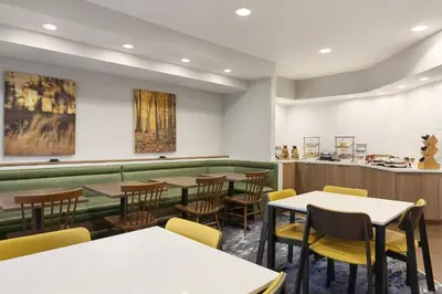 a restaurant with tables and chairs and a counter at Fairfield Inn by Marriott Tracy in Tracy