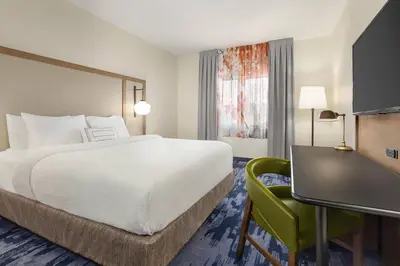 a hotel room with a bed and a desk at Fairfield Inn by Marriott Tracy in Tracy