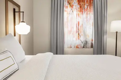 a bedroom with a white bed and a window at Fairfield Inn by Marriott Tracy in Tracy