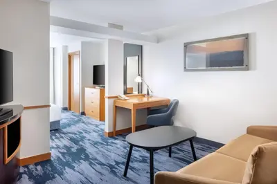 a hotel room with a desk and a chair at Fairfield Inn and Suites Turlock in Turlock
